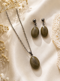 Gunmetal oval cremation memorial jewelry set with pendant necklace and matching drop earrings in natural ash-tone clear resin