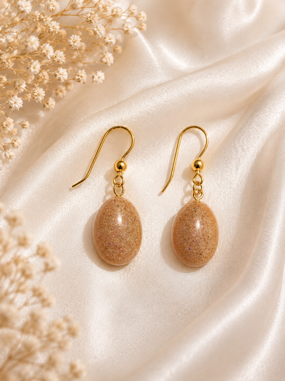 Gold oval cremation memorial drop earrings with natural ash-tone clear resin on gold fish hook wires