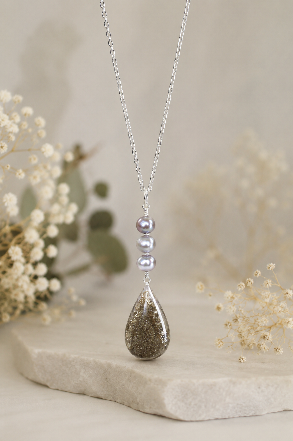 Silver Singapore chain cremation memorial necklace with three graduated gray pearl beads and ash-tone resin teardrop pendant
